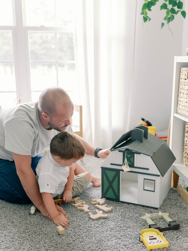 father and son playing on the floor