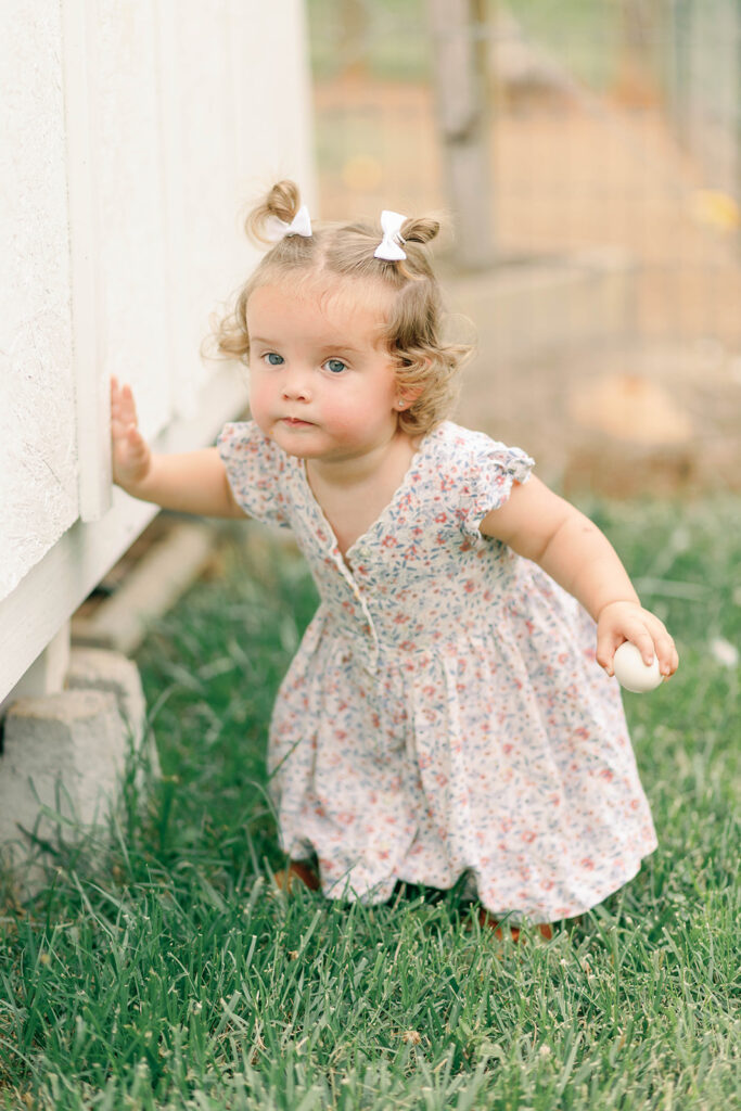 little girl carrying eggs 