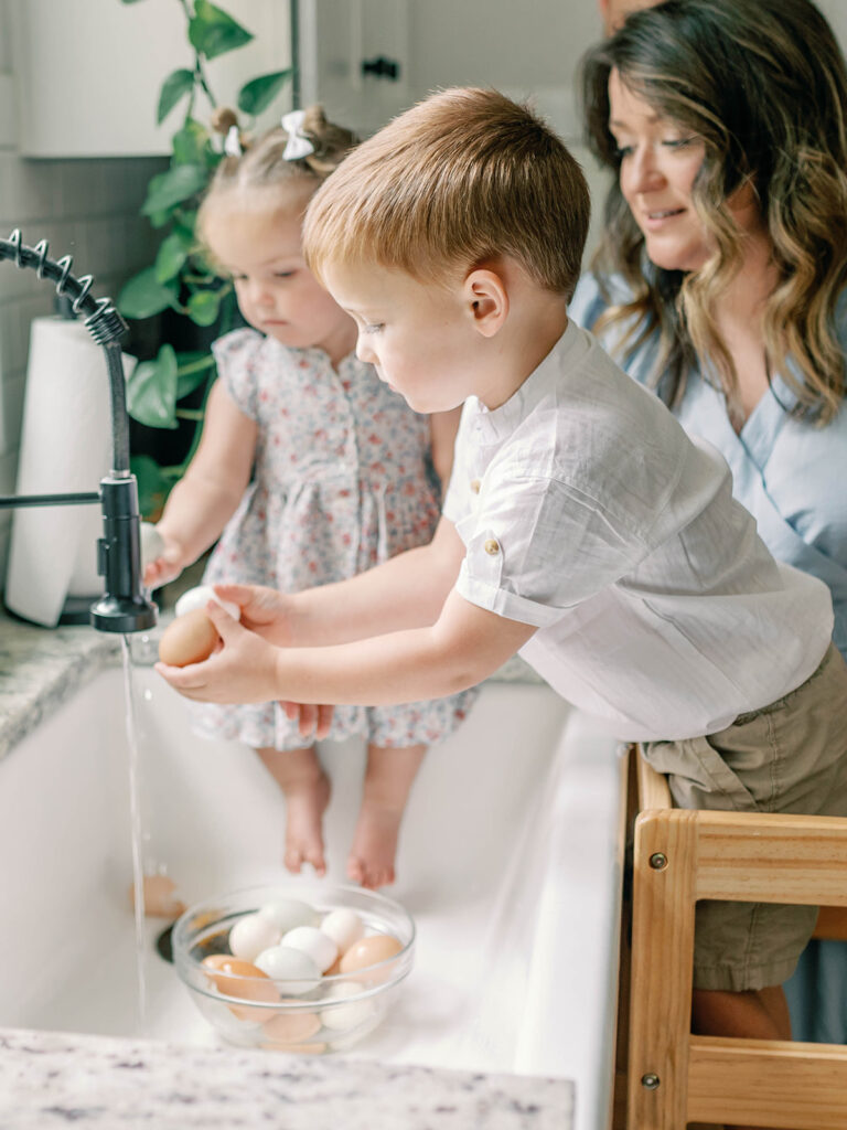 Family washing eggs in sink