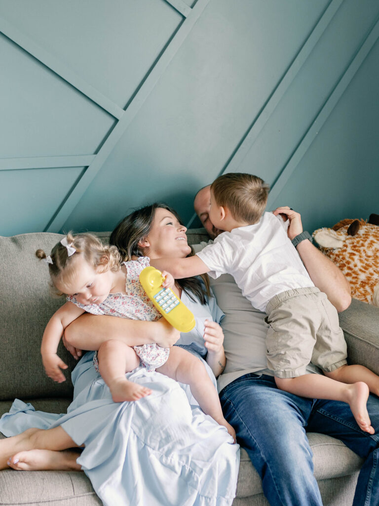 Family snuggling on the couch