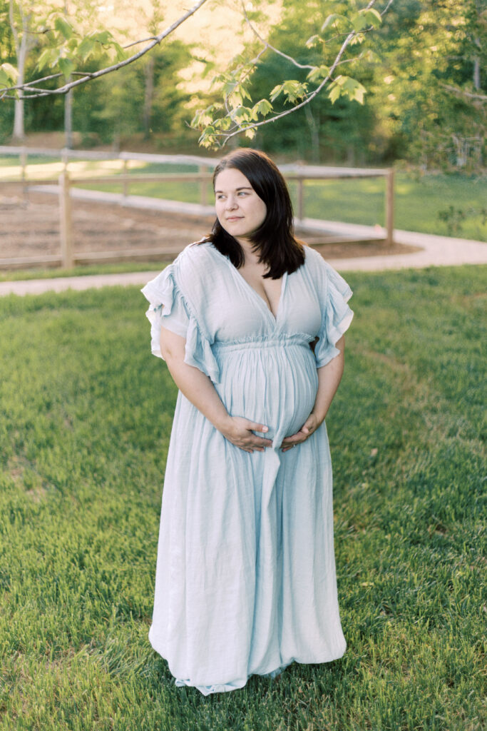 pregnant woman looking over a field